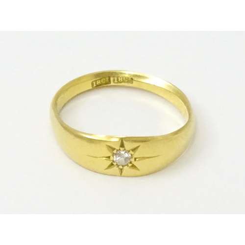 761 - An 18ct gold ring set with central diamond. Ring size approx. L 1/2  (Approx. TW 3.6g)