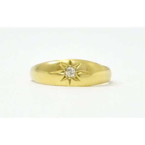 761 - An 18ct gold ring set with central diamond. Ring size approx. L 1/2  (Approx. TW 3.6g)