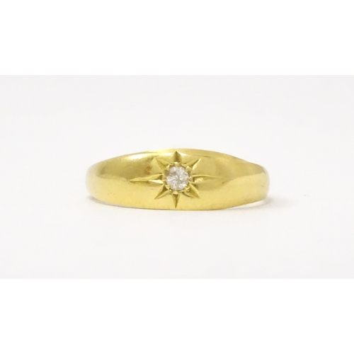 761 - An 18ct gold ring set with central diamond. Ring size approx. L 1/2  (Approx. TW 3.6g)