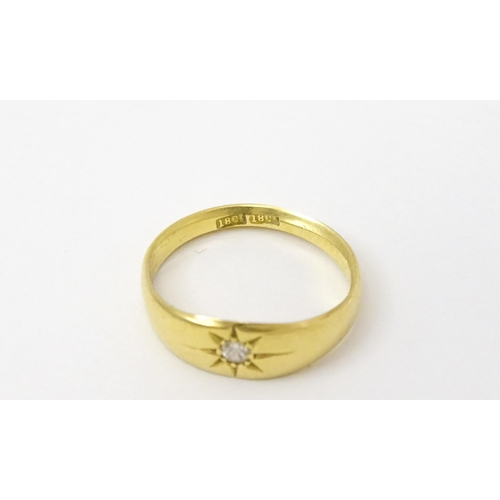 761 - An 18ct gold ring set with central diamond. Ring size approx. L 1/2  (Approx. TW 3.6g)