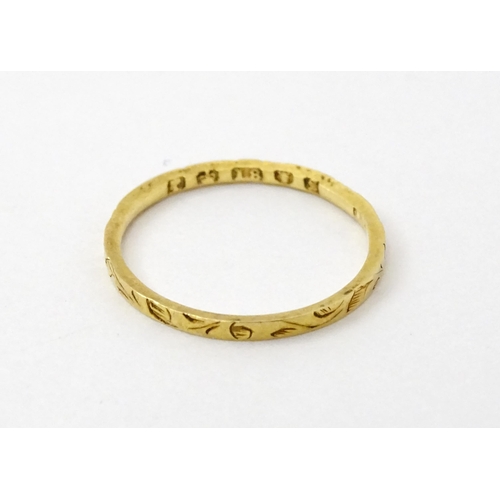 764 - A Victorian 18ct gold ring with engraved decoration. Hallmarked London 1853. Ring size approx.  J (A... 