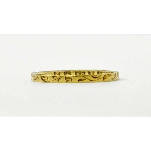 764 - A Victorian 18ct gold ring with engraved decoration. Hallmarked London 1853. Ring size approx.  J (A... 