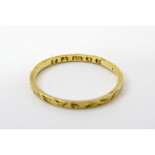 764 - A Victorian 18ct gold ring with engraved decoration. Hallmarked London 1853. Ring size approx.  J (A... 