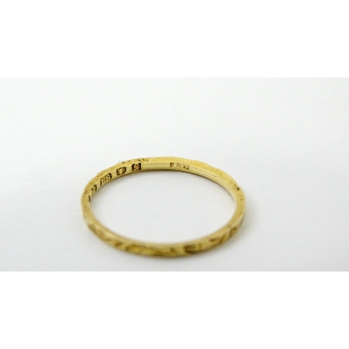 764 - A Victorian 18ct gold ring with engraved decoration. Hallmarked London 1853. Ring size approx.  J (A... 