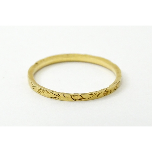 764 - A Victorian 18ct gold ring with engraved decoration. Hallmarked London 1853. Ring size approx.  J (A... 