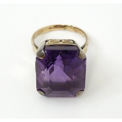 767 - A yellow metal cocktail ring set with amethyst. The amethyst approx 3/4