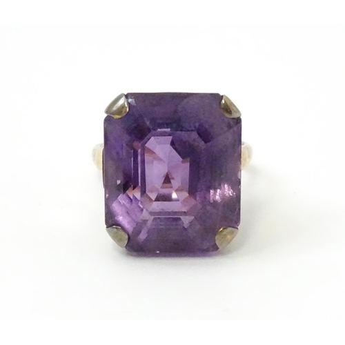 767 - A yellow metal cocktail ring set with amethyst. The amethyst approx 3/4