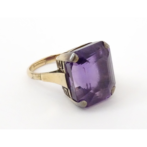 767 - A yellow metal cocktail ring set with amethyst. The amethyst approx 3/4