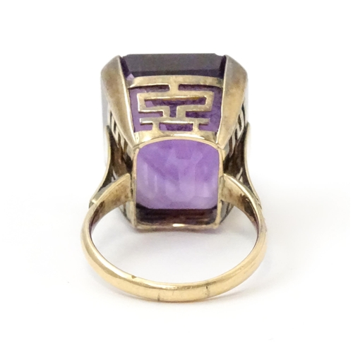 767 - A yellow metal cocktail ring set with amethyst. The amethyst approx 3/4