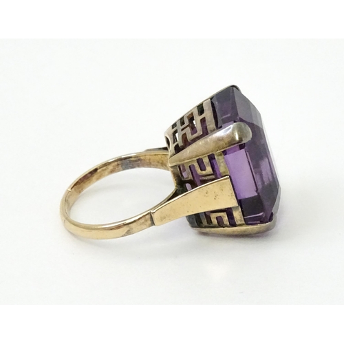 767 - A yellow metal cocktail ring set with amethyst. The amethyst approx 3/4