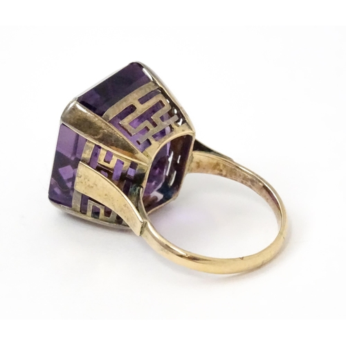 767 - A yellow metal cocktail ring set with amethyst. The amethyst approx 3/4