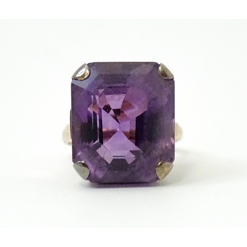 767 - A yellow metal cocktail ring set with amethyst. The amethyst approx 3/4