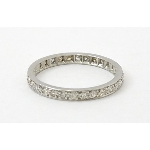 769 - A white metal eternity ring set with diamonds. Ring size approx. O