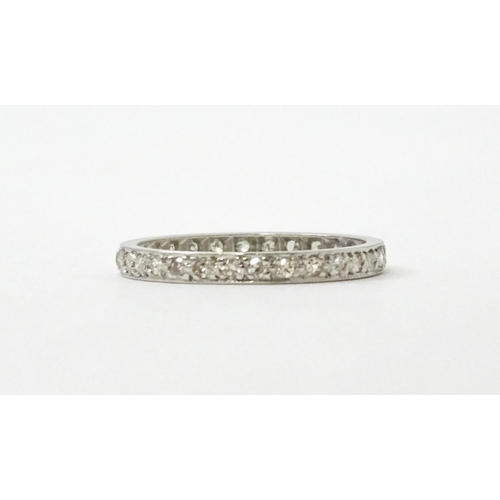 769 - A white metal eternity ring set with diamonds. Ring size approx. O