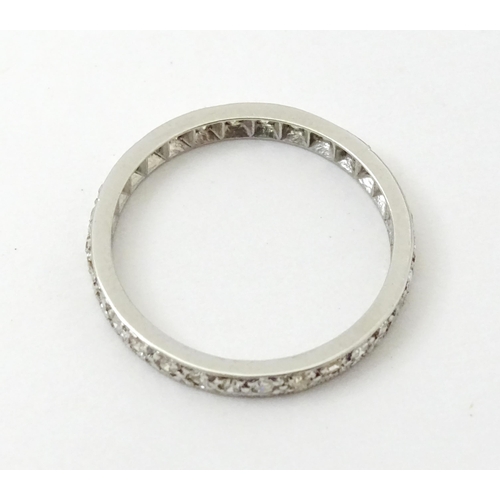 769 - A white metal eternity ring set with diamonds. Ring size approx. O