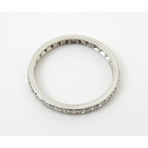 769 - A white metal eternity ring set with diamonds. Ring size approx. O