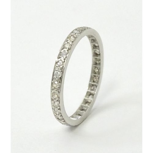 769 - A white metal eternity ring set with diamonds. Ring size approx. O