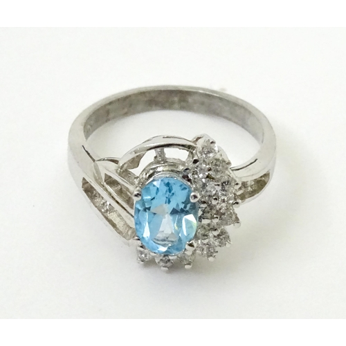 770 - A 9ct white gold ring set with topaz and cubic zirconia. Ring size approx. O