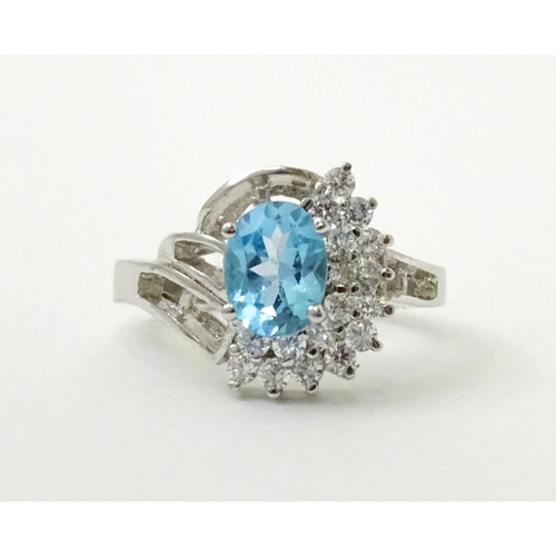 770 - A 9ct white gold ring set with topaz and cubic zirconia. Ring size approx. O