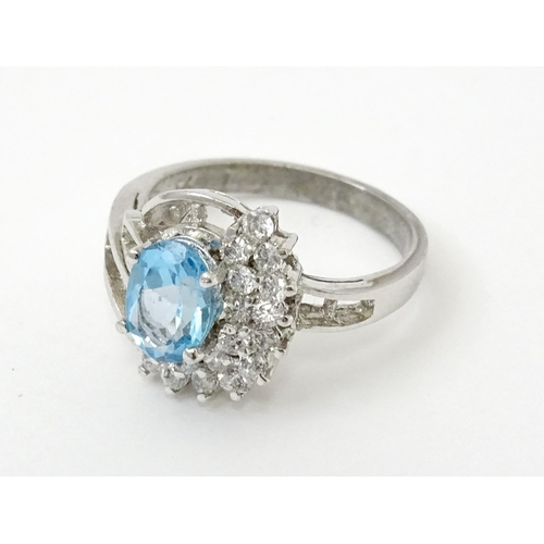 770 - A 9ct white gold ring set with topaz and cubic zirconia. Ring size approx. O