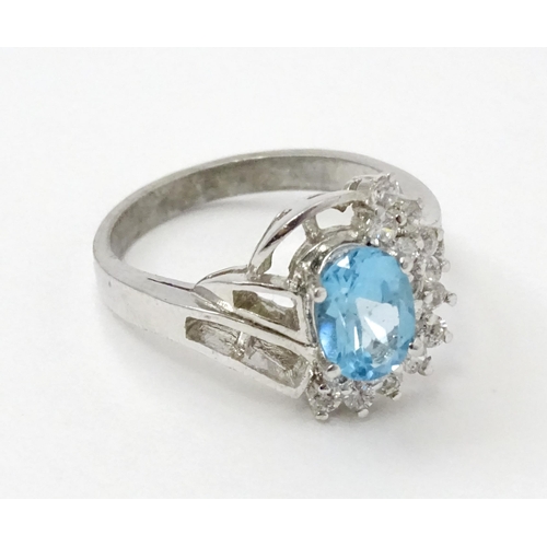 770 - A 9ct white gold ring set with topaz and cubic zirconia. Ring size approx. O