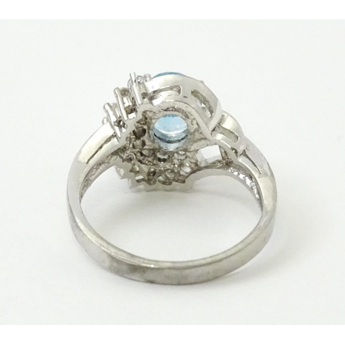 770 - A 9ct white gold ring set with topaz and cubic zirconia. Ring size approx. O