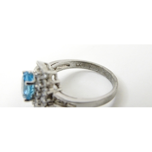 770 - A 9ct white gold ring set with topaz and cubic zirconia. Ring size approx. O