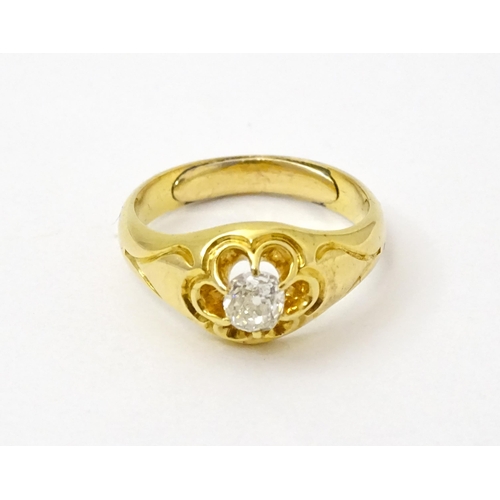 771 - A late 19thC / early 20thC gold ring set with central diamond. Diamond approx 1/8