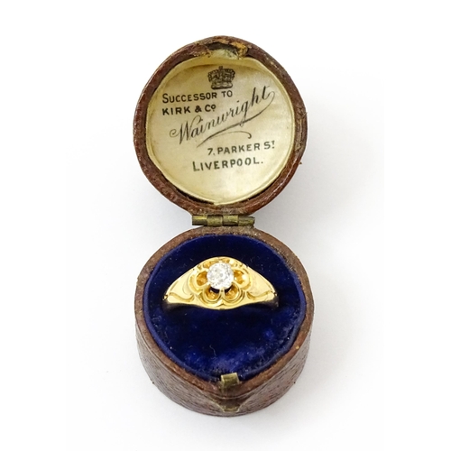 771 - A late 19thC / early 20thC gold ring set with central diamond. Diamond approx 1/8