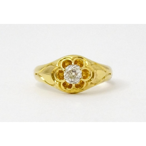 771 - A late 19thC / early 20thC gold ring set with central diamond. Diamond approx 1/8