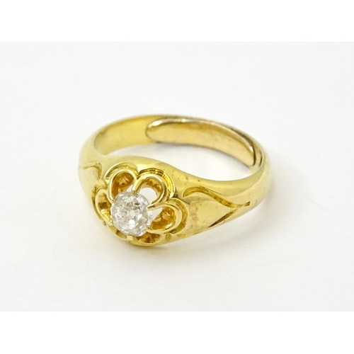 771 - A late 19thC / early 20thC gold ring set with central diamond. Diamond approx 1/8