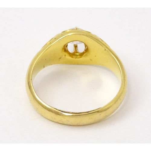 771 - A late 19thC / early 20thC gold ring set with central diamond. Diamond approx 1/8