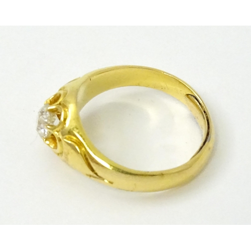 771 - A late 19thC / early 20thC gold ring set with central diamond. Diamond approx 1/8