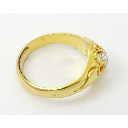 771 - A late 19thC / early 20thC gold ring set with central diamond. Diamond approx 1/8