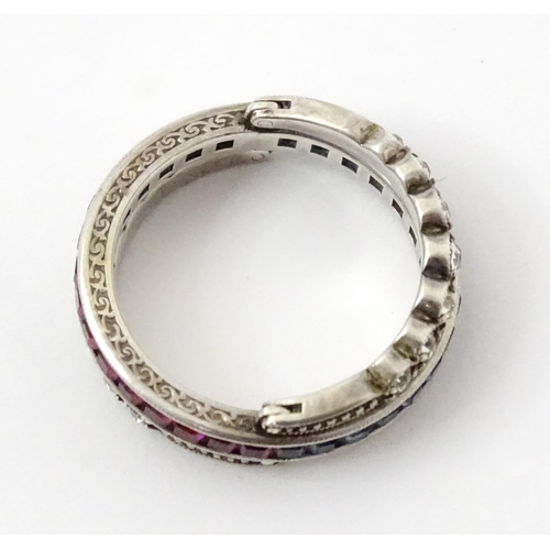 773 - An unusual metamorphic Art Deco eternity ring the central band half set with red stones and half set... 