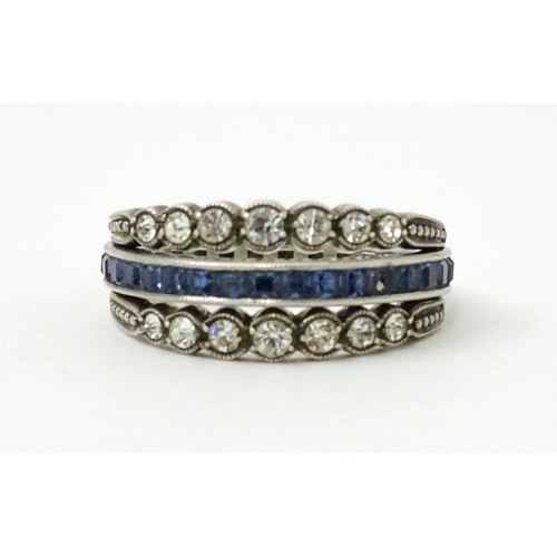 773 - An unusual metamorphic Art Deco eternity ring the central band half set with red stones and half set... 