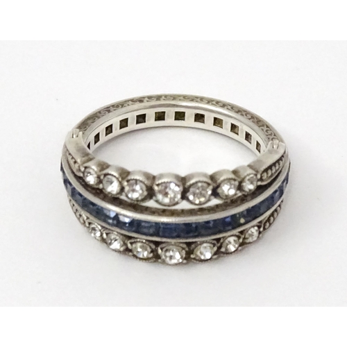 773 - An unusual metamorphic Art Deco eternity ring the central band half set with red stones and half set... 