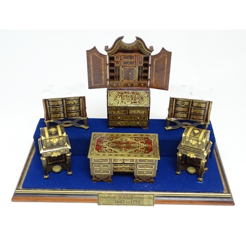 1497 - A showcase containing a display of early 21stC scale model miniature models of furniture to include ... 