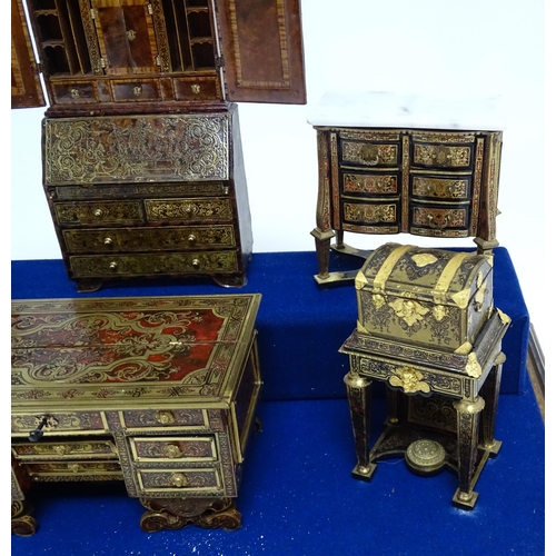 1497 - A showcase containing a display of early 21stC scale model miniature models of furniture to include ... 