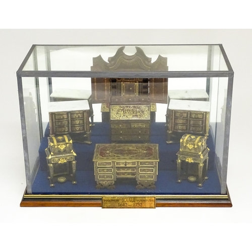 1497 - A showcase containing a display of early 21stC scale model miniature models of furniture to include ... 