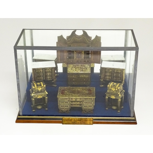 1497 - A showcase containing a display of early 21stC scale model miniature models of furniture to include ... 