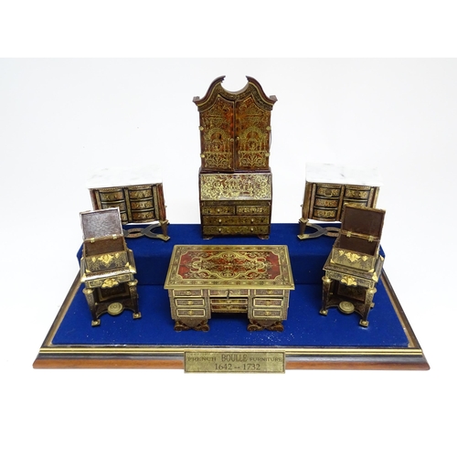 1497 - A showcase containing a display of early 21stC scale model miniature models of furniture to include ... 