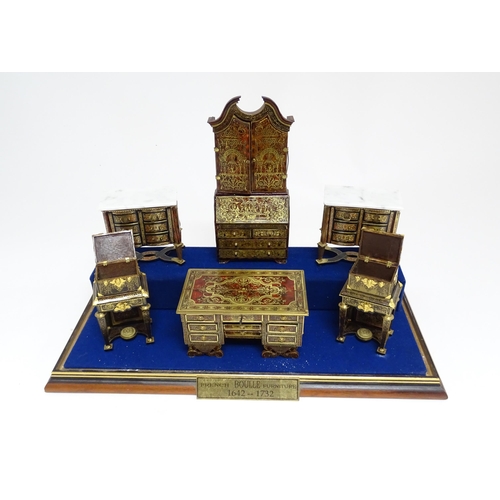 1497 - A showcase containing a display of early 21stC scale model miniature models of furniture to include ... 