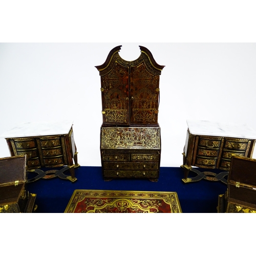 1497 - A showcase containing a display of early 21stC scale model miniature models of furniture to include ... 