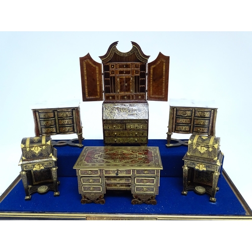 1497 - A showcase containing a display of early 21stC scale model miniature models of furniture to include ... 