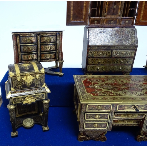 1497 - A showcase containing a display of early 21stC scale model miniature models of furniture to include ... 