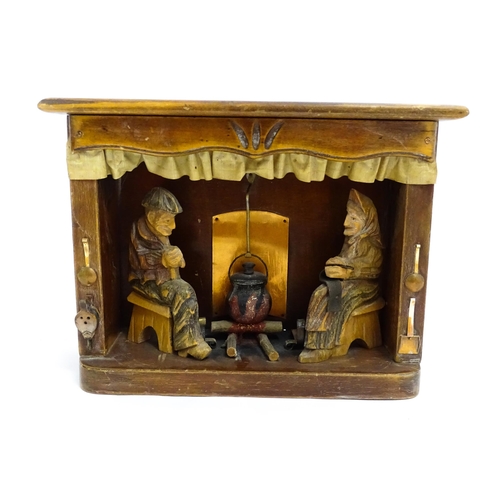 1509 - An early 20thC Continental folk art diorama depicting a naive carved interior scene with man and wom... 