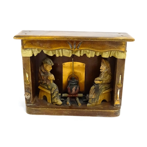 1509 - An early 20thC Continental folk art diorama depicting a naive carved interior scene with man and wom... 