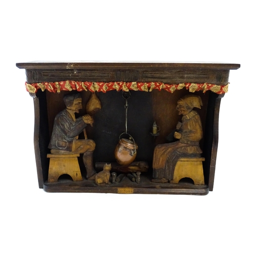 1510 - An early 20thC Continental folk art diorama depicting a naive carved interior scene with man and wom... 