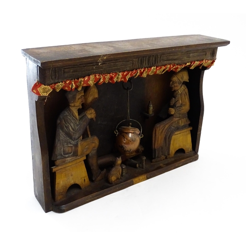 1510 - An early 20thC Continental folk art diorama depicting a naive carved interior scene with man and wom... 